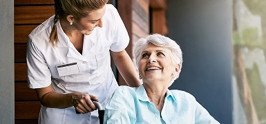 nurse assisting an elderly woman