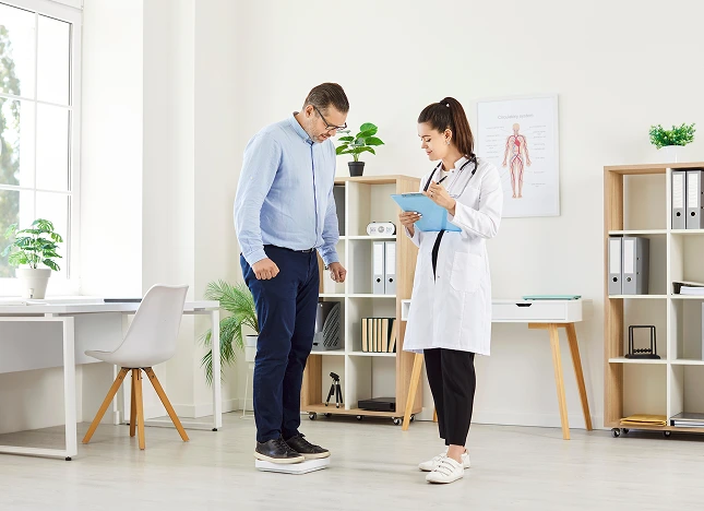 patient standing on a weighing scale