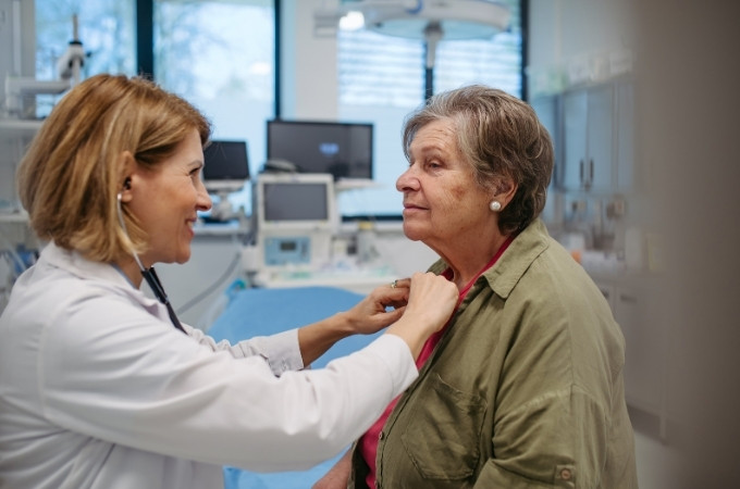 doctor examining an elderly woman