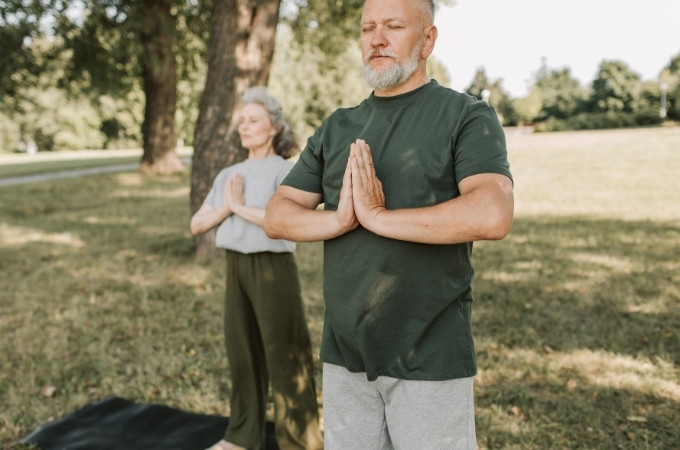 elderly couple doing yoga