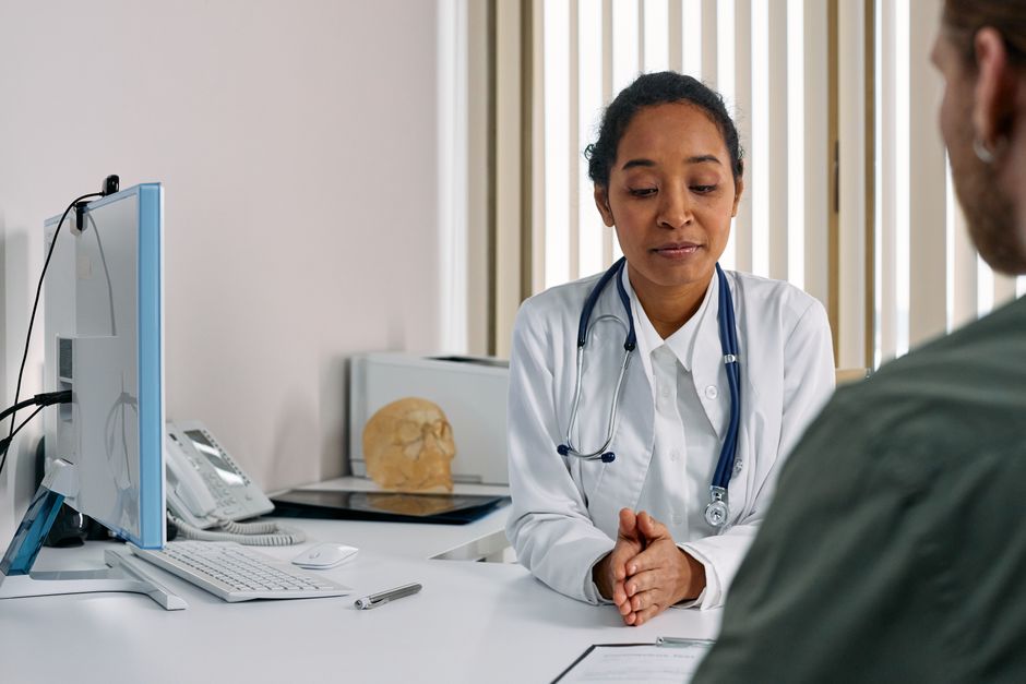 A female doctor consulting with a patient during a well-woman visit at a primary care office