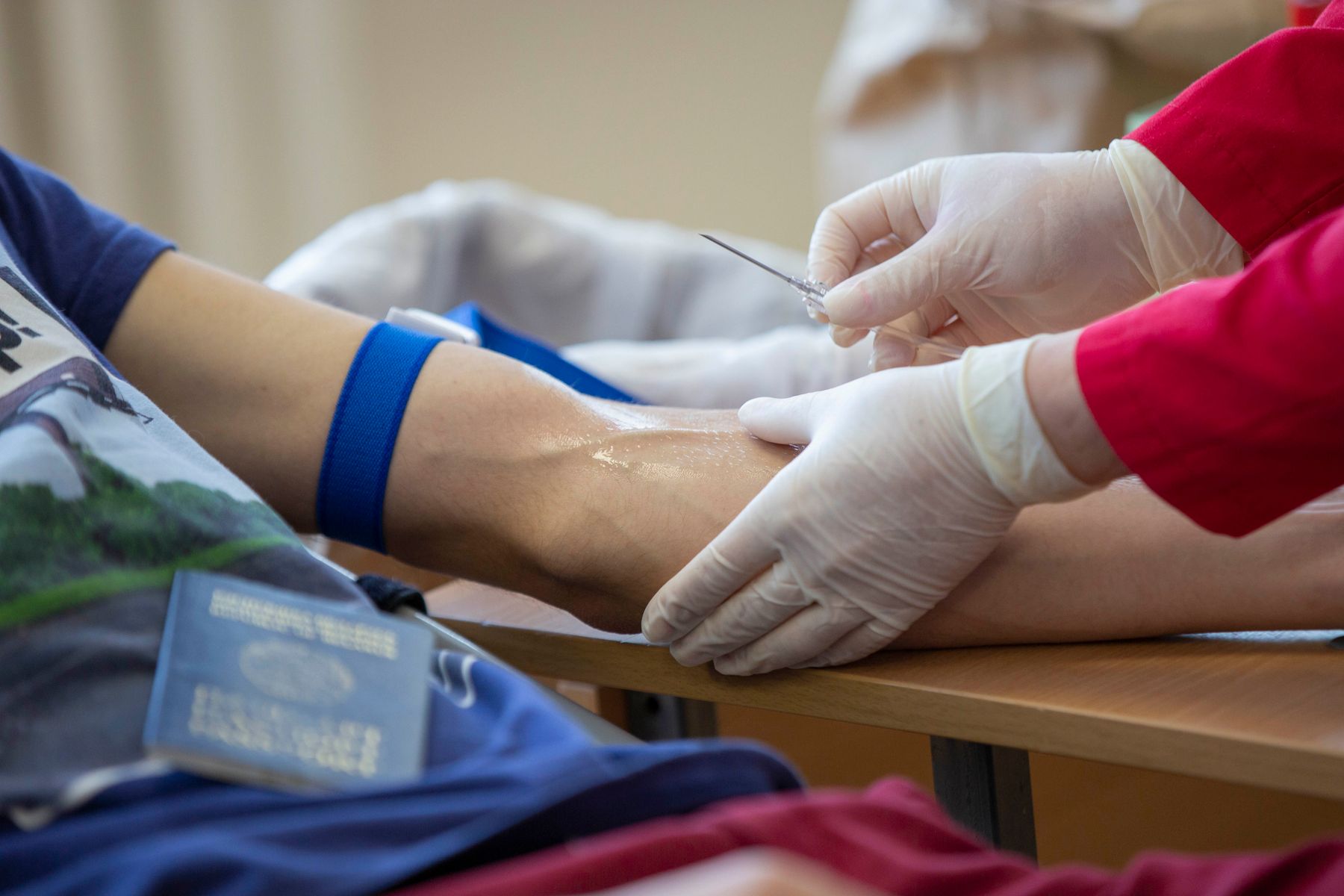Healthcare professional drawing blood from a patient for a cholesterol screening