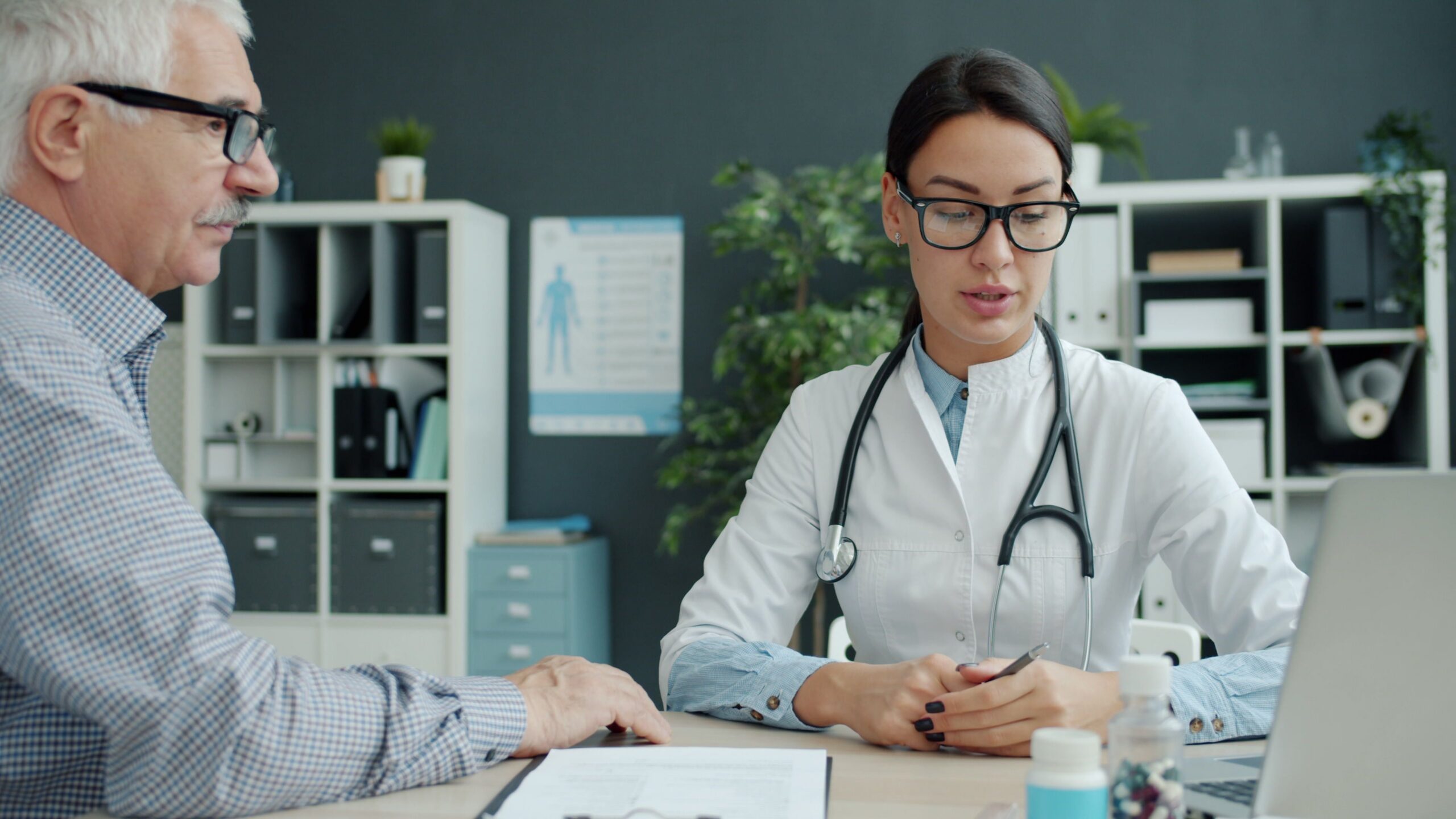 Doctor consulting with a patient about a men's health checkup in a primary care office